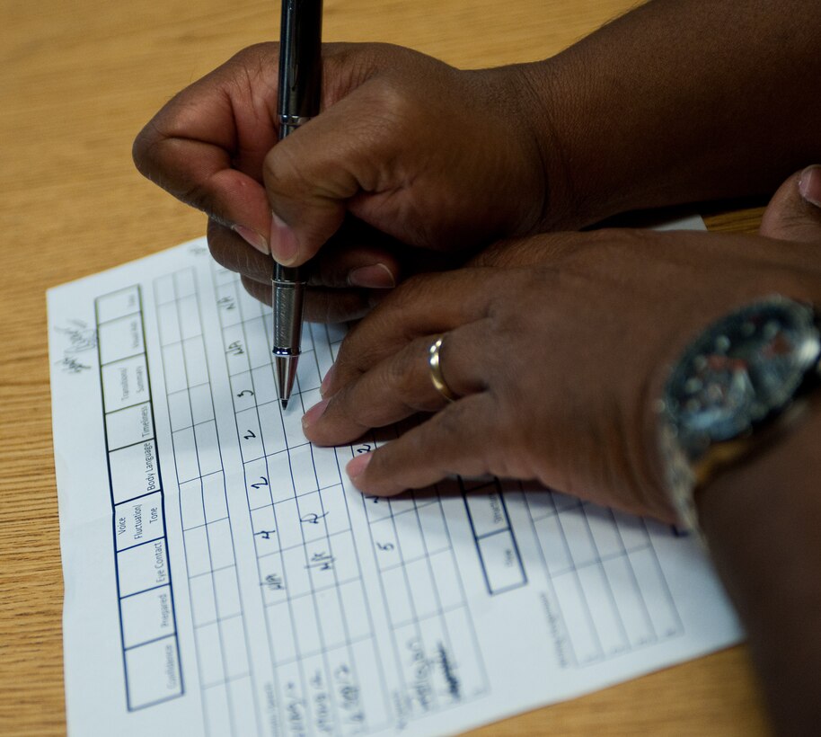 Donald Bell, 28th Bomb Wing equal opportunity director, records scores from impromptu speeches during speech training at Ellsworth Air Force Base, S.D., Sept. 6, 2012. As part of the evaluation process, interns must pick a topic and deliver a speech about that topic for three to five minutes to demonstrate their public speaking skills. (U.S. Air Force photo by Airman 1st Class Alystria Maurer/Released)