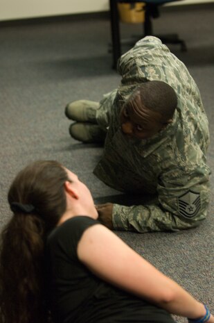 Master Sgt. Antonio Shaheed, 823rd Maintenance Squadron specialist section chief, does a side plank as instructed by Lacy Puttuck, 99th Aerospace Medical Squadron Health and Wellness Center nutrition program manager during a Better Body Better Life Class Sept. 7, 2012, at the HAWC here. (U.S. Air Force photo by Senior Airman Jack Sanders)