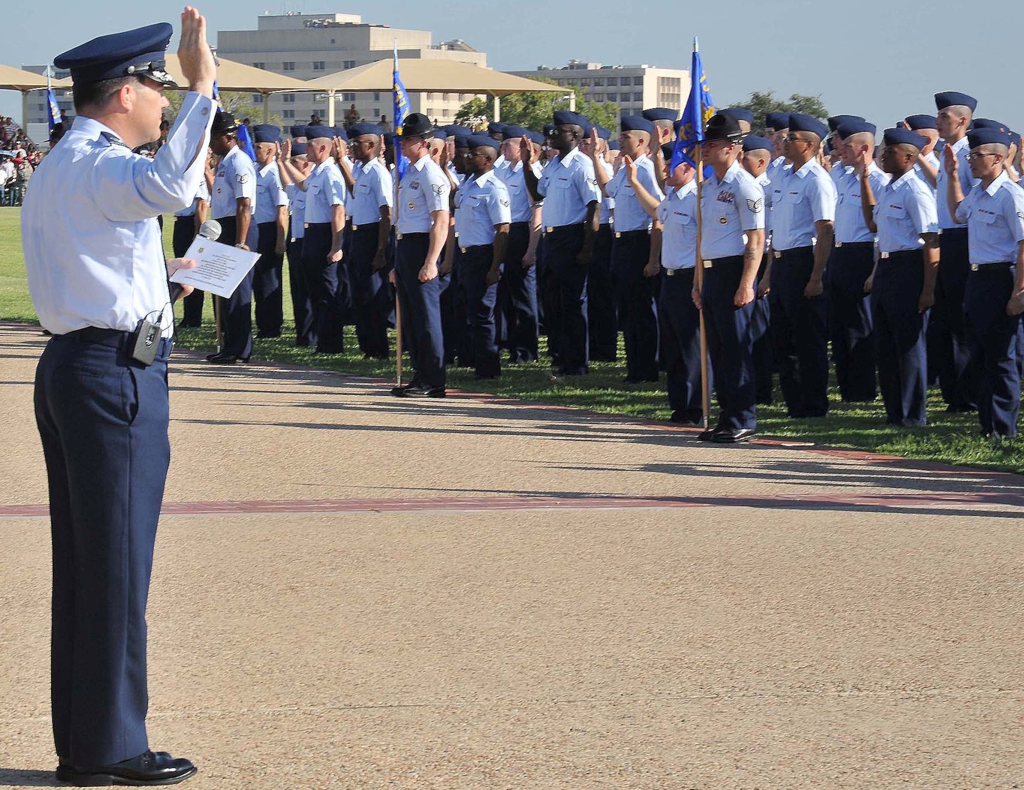 Col. Jerry Couvillion, Air Force Personnel Center, administers the oath of enlistment to the Sept. 7 Air Force basic training graduates, one of whom was his son Airman Basic Patrick Couvillion. (U.S. Air Force photo by Alan Boedeker)