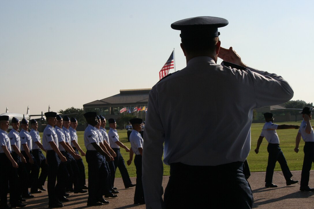 Air Force Personnel Center Director of Personnel Services Col. Jerry Couvillion salutes Air Force basic military training graduates as they pass in review during the Sept. 7 graduation ceremony. Couvillion served as the reviewing official for his son’s BMT graduation. (U.S. Air Force photo by Debbie Gildea)