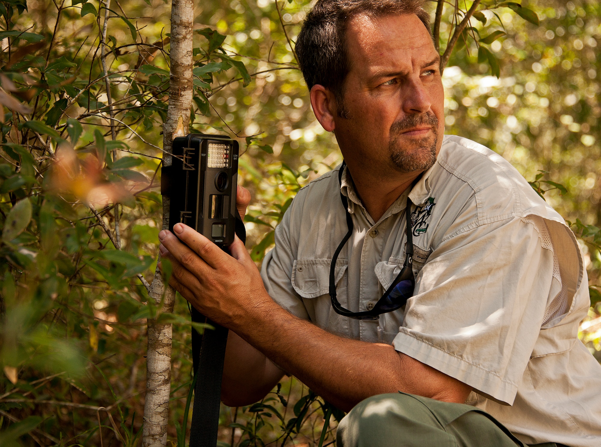 Kevin McDonald, a wildlife technician with the Florida Fish and Wildlife Conservation Commission, sets up an infra-red camera to document the activities around a bear trap set up nearby in Poquito Bayou, a section of base housing on Eglin Air Force Base, Fla., Sept. 10. Recent sightings of Florida Black Bears in the region have kept the FWC busy. According to 96th Civil Engineer Group wildlife management experts, people should make every attempt to secure their trash to prevent the bears from finding an easy food source, which eliminates their need to forage in the forest. (U.S. Air Force photo/Samuel King Jr.)