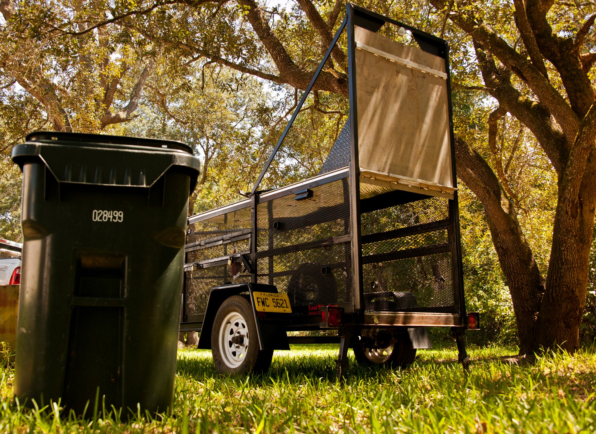 A bear trap is set up beside a trash container in Poquito Bayou, a section of base housing on Eglin Air Force Base, Fla., Sept. 10. Recent sightings of Florida Black Bears in the region have kept the FWC busy. According to 96th Civil Engineer Group wildlife management experts, people should make every attempt to secure their trash to prevent the bears from finding an easy food source, which eliminates their need to forage in the forest. (U.S. Air Force photo/Samuel King Jr.)