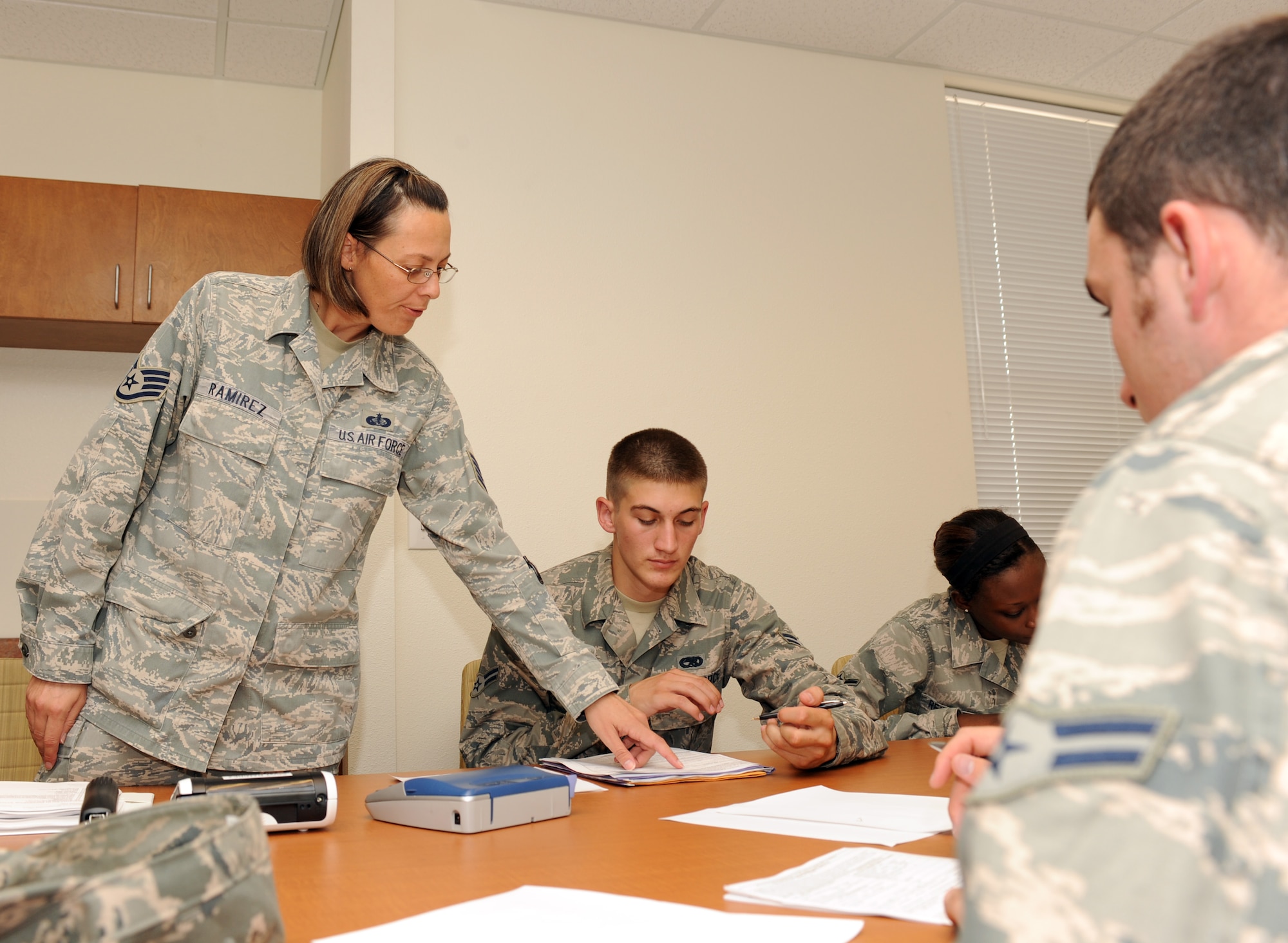 U.S. Air Force Staff Sgt. Johanie Ramirez, 355th Civil Engineer Squadron Airman dormitory leader, briefs new dorm residents during a mass in-processing brief on Davis-Monthan Air Force Base, Ariz., Sept. 6, 2012. ADLs brief Airmen on the rules and procedures they are expected to follow as well as provide useful information in case of emergencies during the briefings that are held every Thursday. (U.S. Air Force photo by Airman 1st Class Timothy Moore/Released)