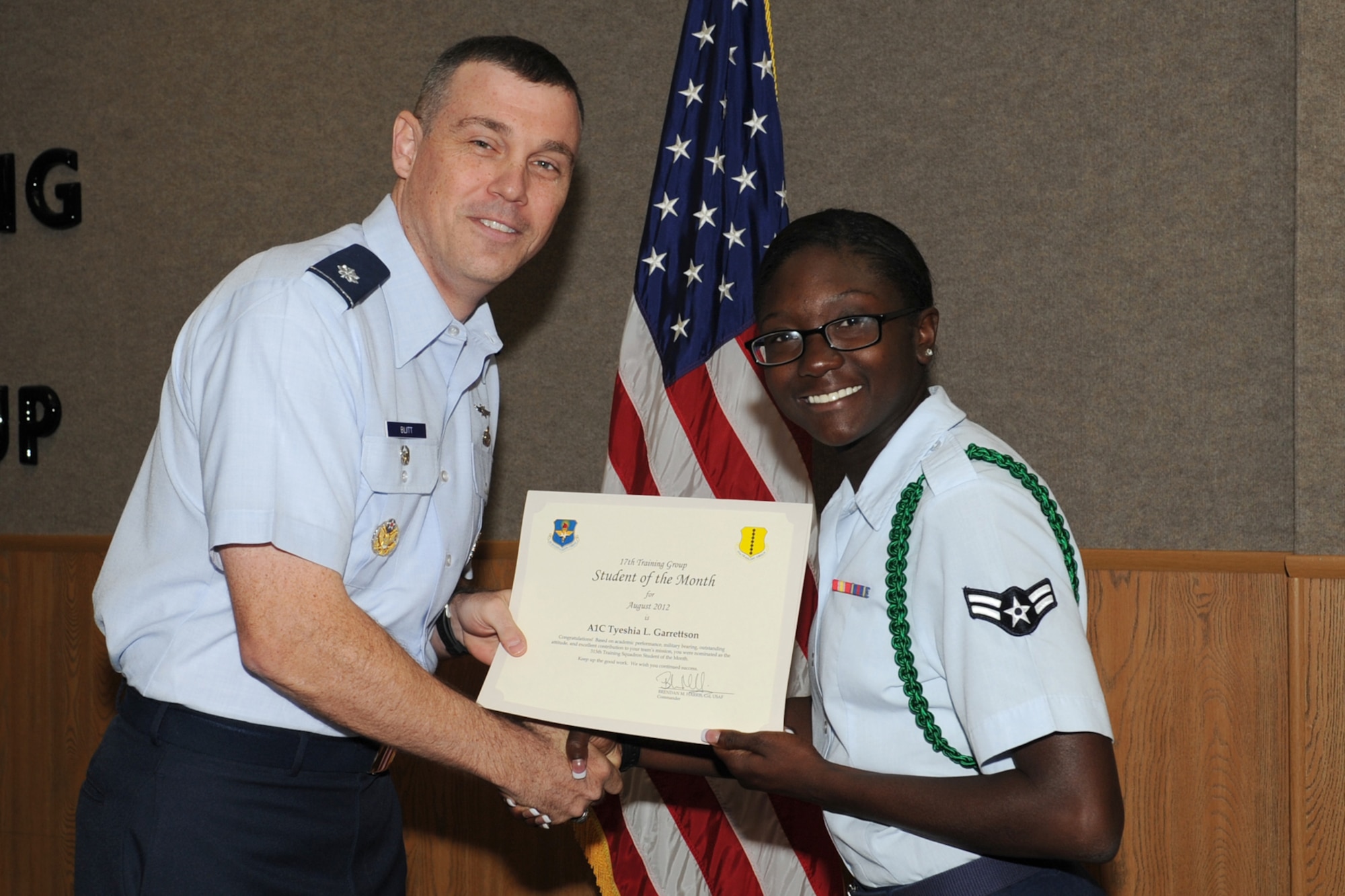 U.S. Air Force Lt. Col. Edward Blitt, 17th Training Group deputy commander, presents Airman 1st Class Tyeshia Garrettson with the 315th Training Squadron Enlisted Student of the Month award for August at Goodfellow Air Force Base, Texas, Sept. 7, 2012. (U.S. Air Force photo by Staff Sgt. Laura R. McFarlane)