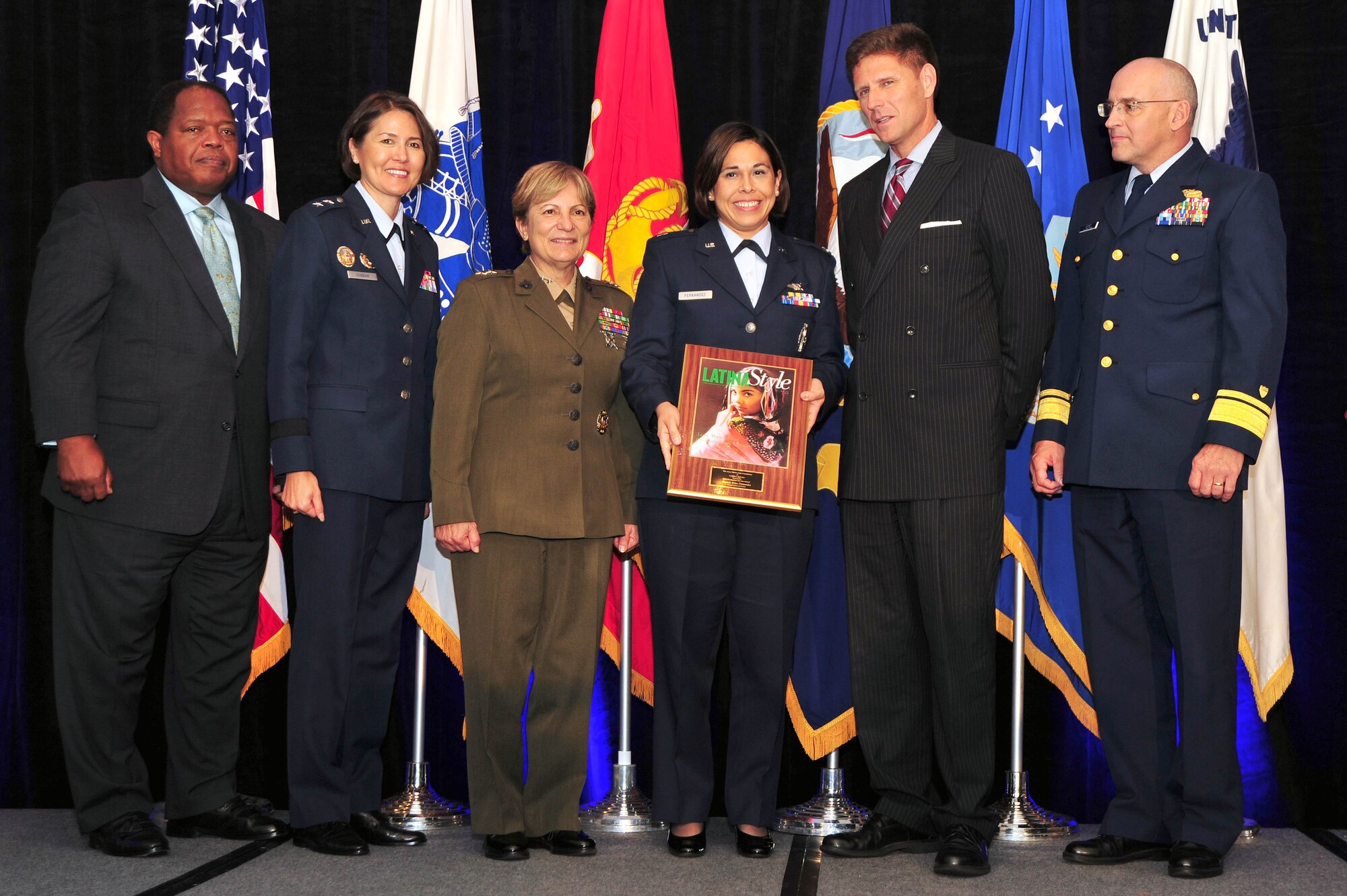 Military leadership and Latina Style Inc. partners present the 2012 Latina Style Meritorious Service Award to Capt. Erica Fernandez, Headquarters USAF Deputy Chief of Staff Manpower, Personnel and Services Force Development, during the 9th Annual Latina Symposium Distinguished Military Awards Ceremony, Sept. 6, in Arlington, Va. Fernandez received the award for her unwavering dedication and a ?can do? attitude as a stand-out performer at Headquarters USAF and throughout the Latina community. (U.S. Air Force photo by Senior Airman Steele C. G. Britton)