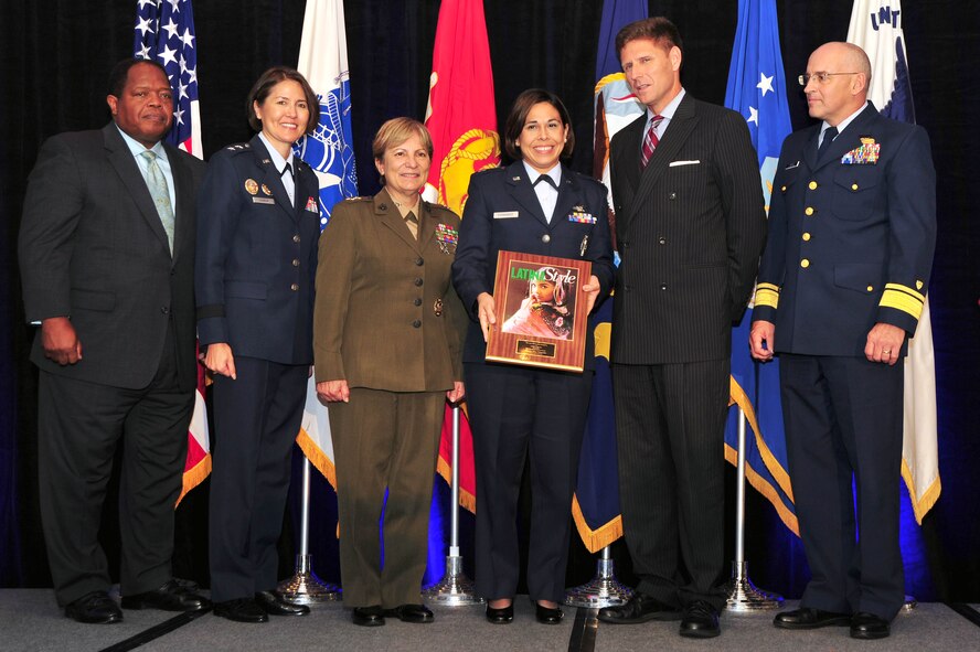 Military leadership and Latina Style Inc. partners present the 2012 Latina Style Meritorious Service Award to Capt. Erica Fernandez, Headquarters USAF Deputy Chief of Staff Manpower, Personnel and Services Force Development, during the 9th Annual Latina Symposium Distinguished Military Awards Ceremony, Sept. 6, in Arlington, Va. Fernandez received the award for her unwavering dedication and a can do attitude as a stand-out performer at Headquarters USAF and throughout the Latina community. (U.S. Air Force photo by Senior Airman Steele C. G. Britton) 