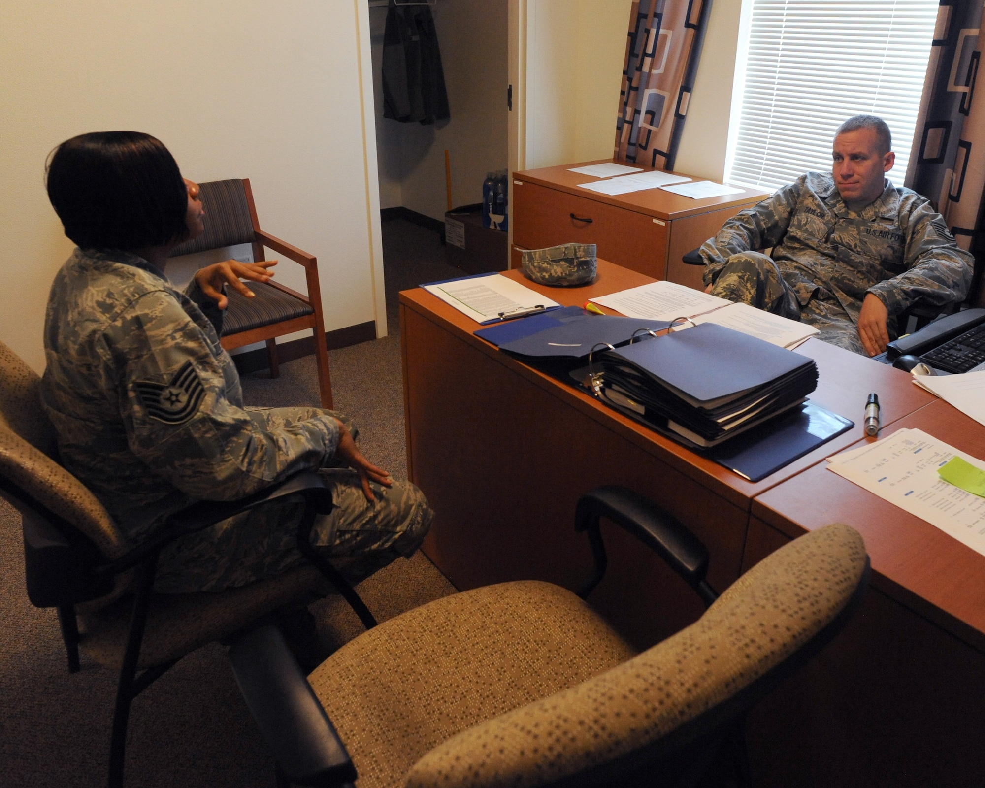 U.S. Air Force Tech. Sgts. Ebony Leach and Shawn Taylor, 355th Civil Engineer Squadron Airman dormitory leaders, discuss issues concerning the dorm residents of Davis-Monthan Air Force Base, Ariz., Sept. 5, 2012. Along with dealing with dorm issues, ADLs also plan events to help increase espirit de corps among dorm residents. (U.S. Air Force photo by Airman 1st Class Timothy Moore/Released)