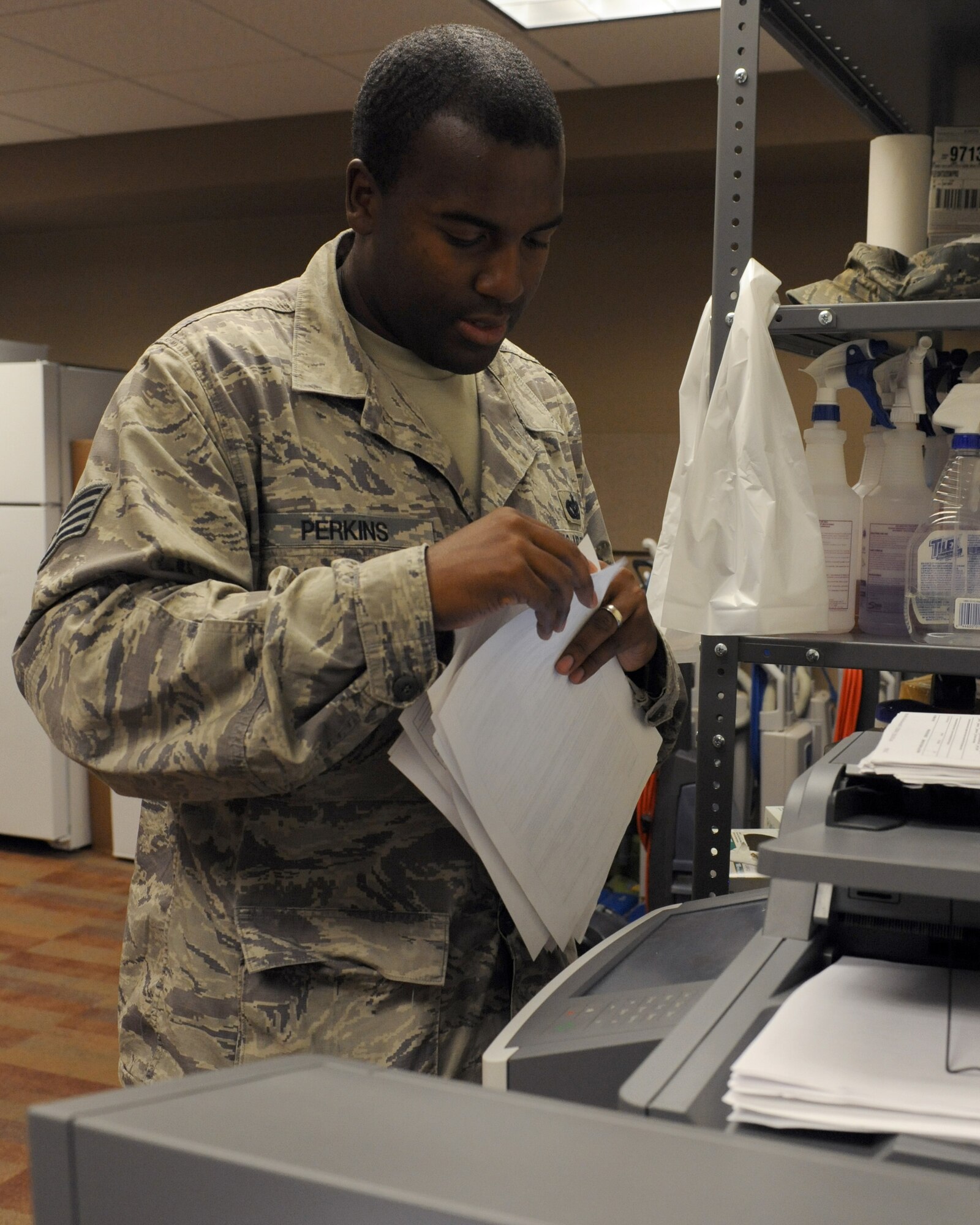 U.S. Air Force Staff Sgt. Earnest Perkins, 355th Civil Engineer Squadron Airman dormitory leader, scans files into the ADLs' electronic filing system on Davis-Monthan Air Force Base, Ariz., Sept. 5, 2012. The electronic filing system helps organize files on more than 600 current dorm residents as well as past residents. (U.S. Air Force photo by Airman 1st Class Timothy Moore/Released)