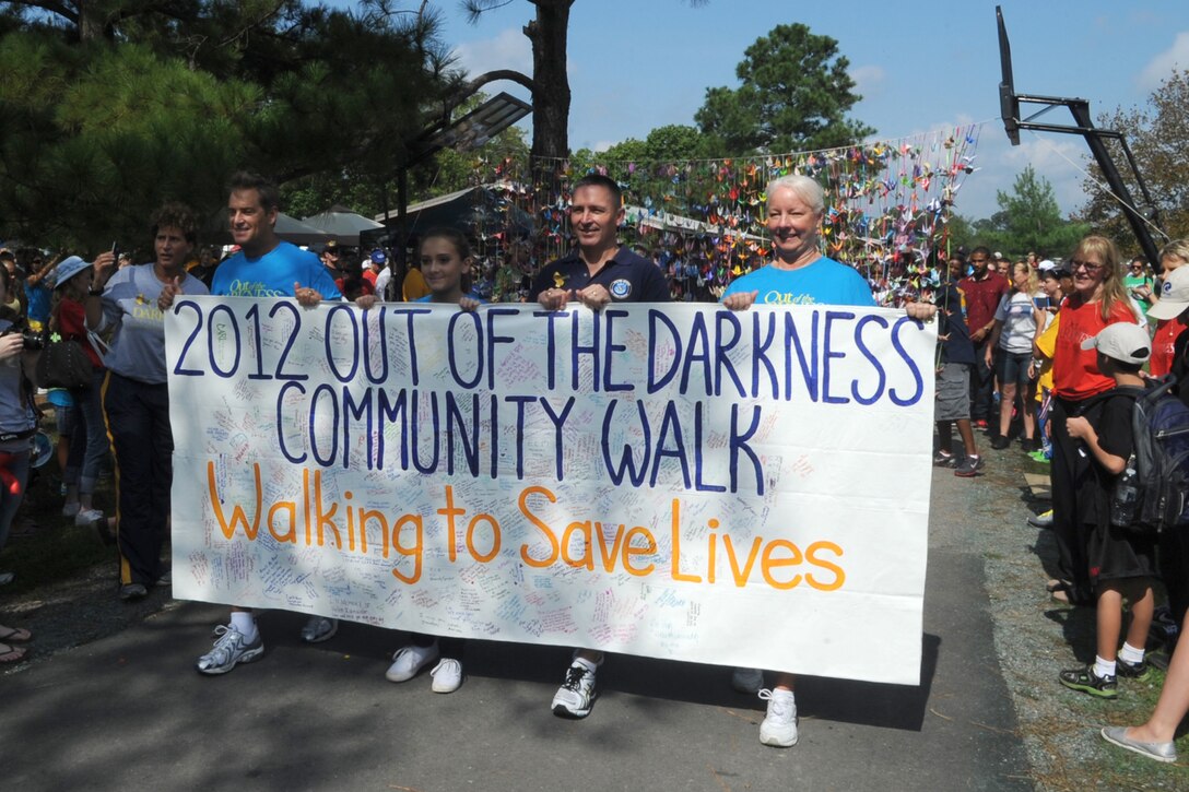 Hampton Roads community members join together to raise suicide awareness during the Out of Darkness Walk at Mount Trashmore Park in Virginia Beach, Va., Sept. 8, 2012. According to the American Foundation for Suicide Prevention, a life is lost to suicide every 18 minutes in the United States.  The impact suicide has on the lives of surviving family members, friends, co-workers and neighbors can be devastating and long-lasting. (U.S. Air Force photo by Senior Airman Racheal Watson/Released)