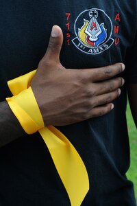 U.S. Air Force Staff Sgt. Micah Amey, 439th Supply Chain Operations record maintenance technician, wears a yellow ribbon, during the Out of the Darkness Walk at Mount Trashmore Park in Virginia Beach, Va., Sept. 8, 2012, to signify losing an extended family member to suicide. Suicide is this country's ninth leading cause of death, and it is estimated for every suicide, at least six other people, including family members, friends and co-workers, are intimately affected. (U.S. Air Force photo by Senior Airman Racheal Watson/Released)