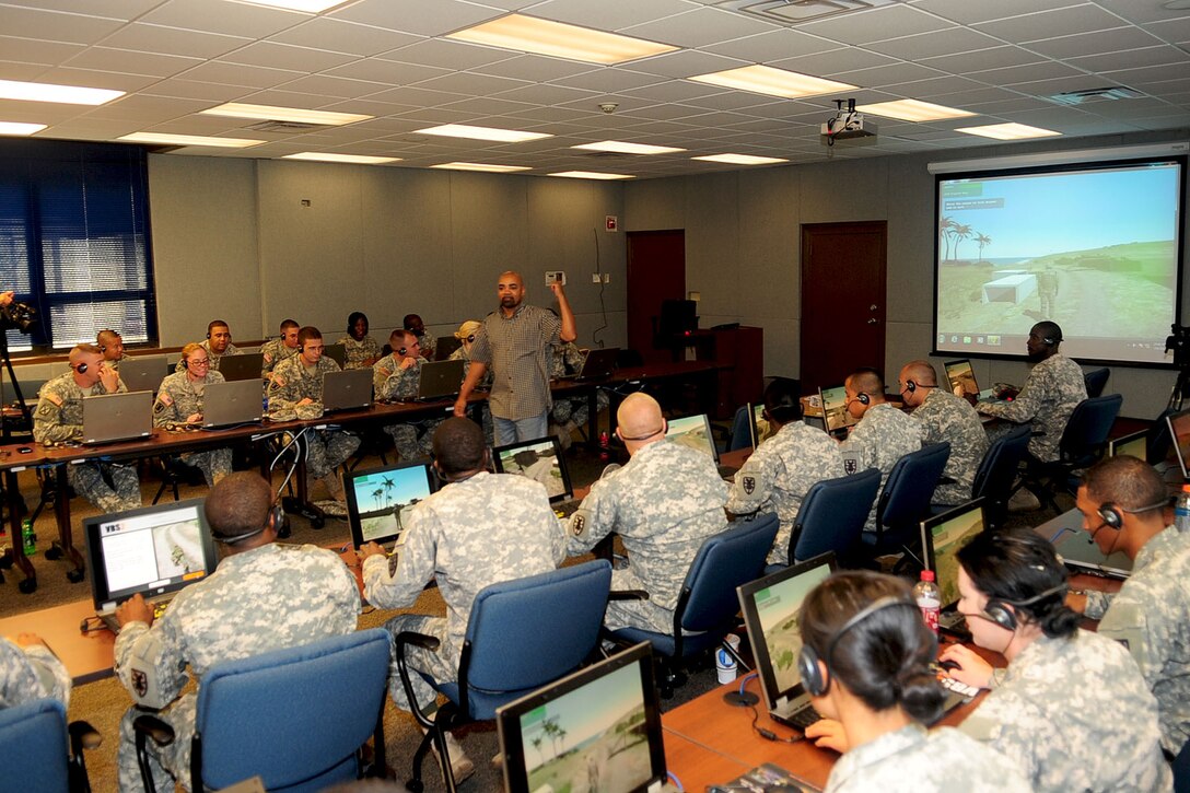 Ed Donaldson, Army Support Activity simulations specialist, explains the various scenarios available through the Virtual Battle Space 2 simulator training at Fort Eustis, Va., Sept. 6, 2012. The ASA uses VBS2 simulated battlefield scenarios to train Soldiers; accurately recreating elements such as fire-control systems, physics and weapon ballistics. (U.S. Air Force photo by Staff Sgt. Ashley Hawkins/Released)