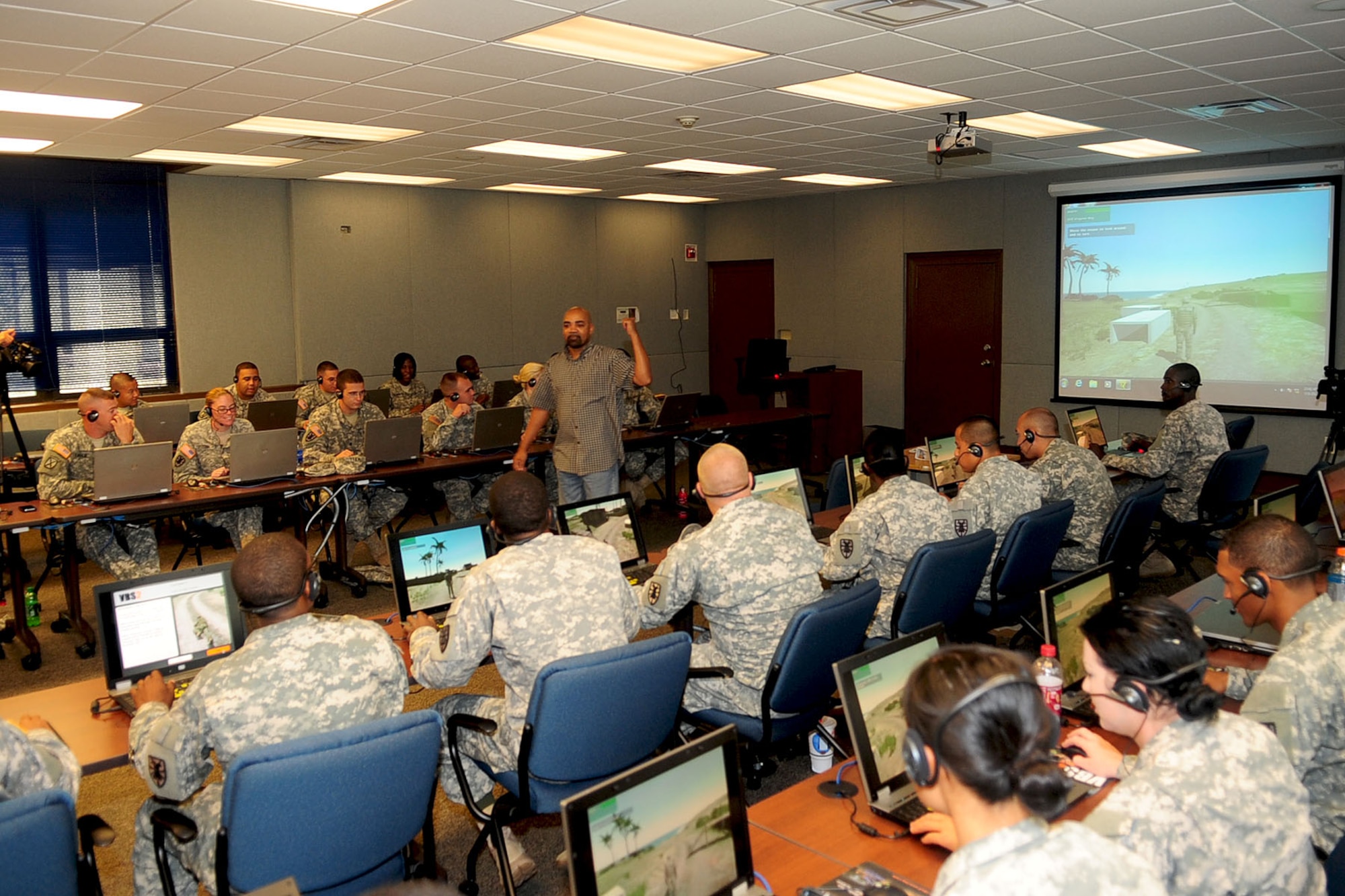 Ed Donaldson, Army Support Activity simulations specialist, explains the various scenarios available through the Virtual Battle Space 2 simulator training at Fort Eustis, Va., Sept. 6, 2012. The ASA uses VBS2 simulated battlefield scenarios to train Soldiers; accurately recreating elements such as fire-control systems, physics and weapon ballistics. (U.S. Air Force photo by Staff Sgt. Ashley Hawkins/Released)