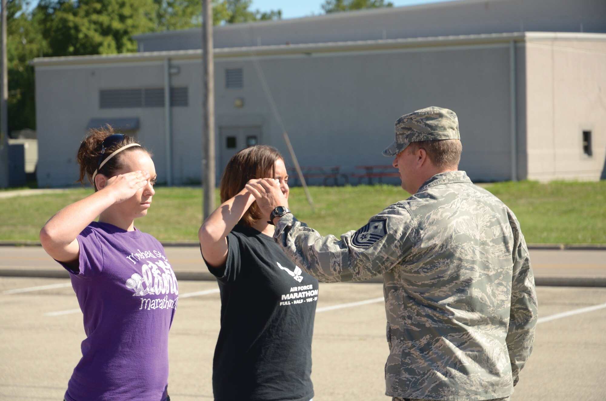 WRIGHT-PATTERSON AIR FORCE BASE, Ohio - Master Sgt. Steven Purvis, 445th Development and Training Flight NCO in charge, adjusts the salute of trainee Melissa Sherman as trainee Dakota Kierner waits for inspection. The 445th AIrlift Wing's D&TF is a new Air Force Reserve Command program designed to increase the completion rate and save the AFRC money by preparing recruits for BMT through a thorough introduction to the Air Force Reserve.  (U.S. Air Force photo/Capt. John Stamm)