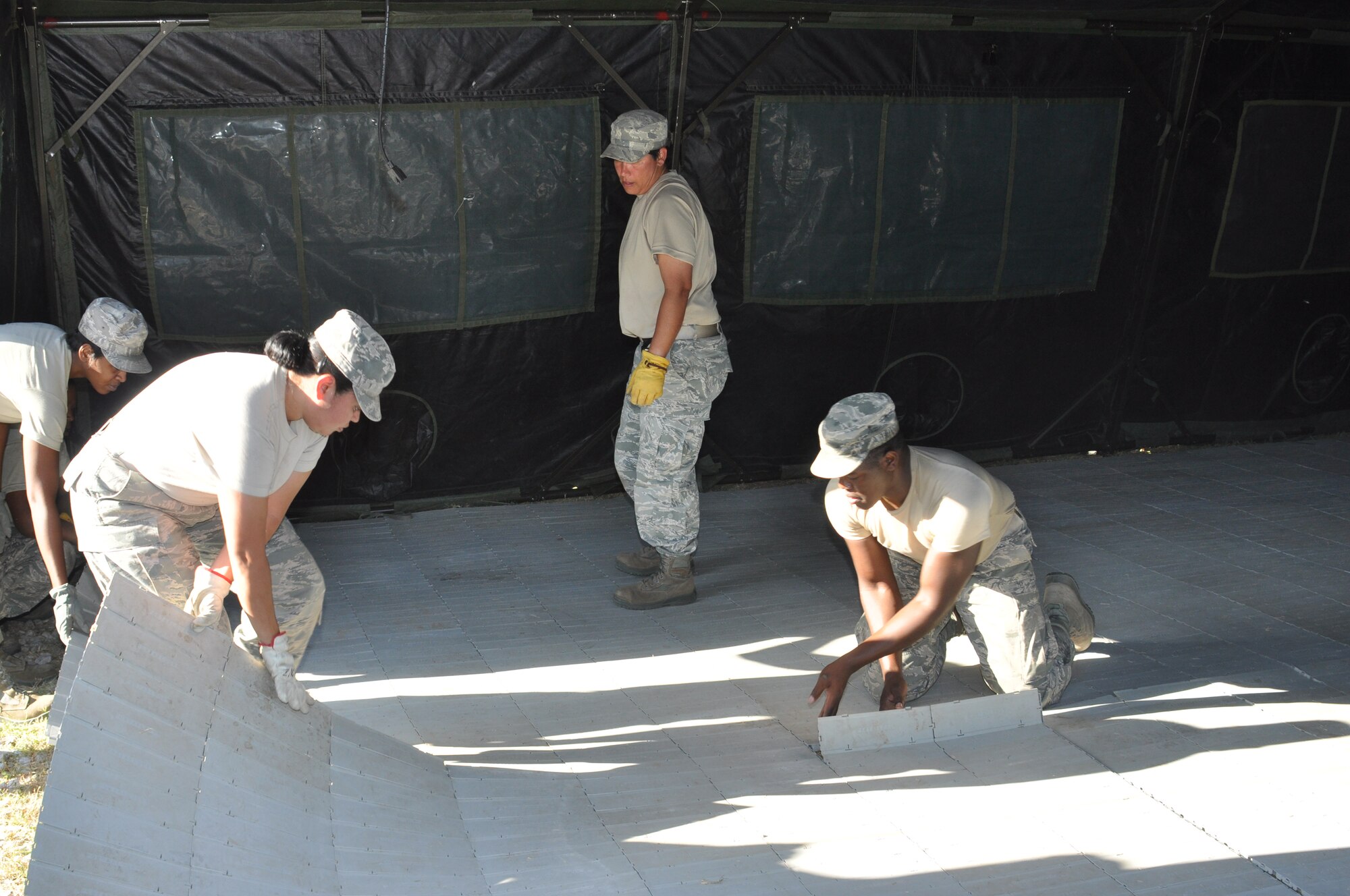 Team members from the 301st Sustainment Services Flight race against the clock to erect the tent component of the Single Pallet Expeditionary Kitchen during an evaluation by Hennessy Trophy evaluators during the August UTA.  The team has just an hour and a half to erect and set up the kitchen facility as part of the Hennessy Trophy Award evaluation.   (U.S. Air Force photo/Tech. Sgt. Chris Bolen)