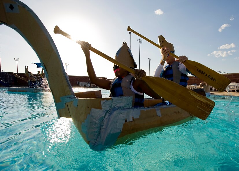 The first shirt team paddles across a swimming pool in their vessel Sept. 4, 2012, during a build-a-boat competition at Dyess Air Force Base, Texas. Participants were given one hour to build their boats from cardboard and duct tape, and row from one end of a pool to the other without sinking. This year’s winner was the Dyess metal shop team. (U.S. Air Force photo by Airman 1st Class Damon Kasberg/Released)
