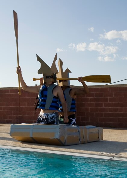 Members of the Dyess metal shop team yell their chant Sept. 4, 2012, during a build-a-boat competition at Dyess Air Force Base, Texas. Participants were given one hour to build their boats from cardboard and duct tape, and row from one end of a pool to the other without sinking. This year’s winner was the Dyess metal shop team. (U.S. Air Force photo by Airman 1st Class Damon Kasberg/Released)