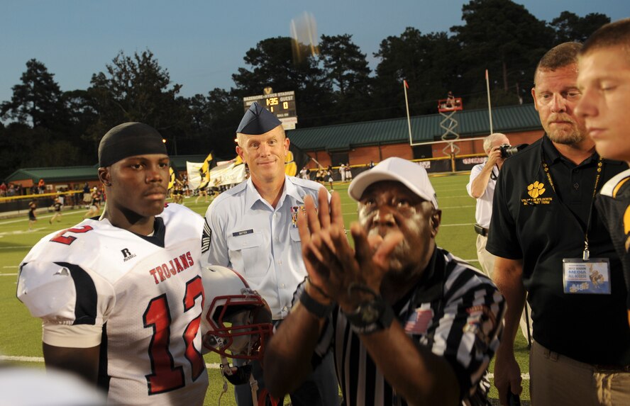 U.S. Air Force Chief Master Sgt. Frank Batten, 23d Wing command chief, watches as a referee performs a coin toss during a football game at the Bazemore-Hyder Stadium in Valdosta Ga., Sept. 7, 2012. The game was between the Valdosta High School Wildcats and the Brooks County High School Trojans. (U.S. Air Force photo by Senior Airman Douglas Ellis/Released)
