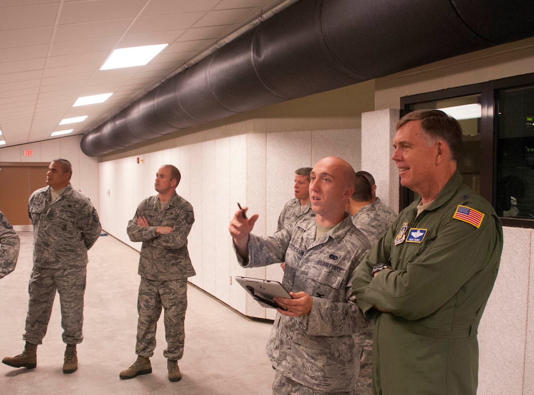 U.S. Air Force Maj Gen Wallace Farris observes Staff Sgt. Shawn Saddleson of the 914th Security Forces Squadron give an equipment demonstration in the newly constructed indoor firing range on base Sept. 9. Farris, 22nd Air Force Commander visited Niagara during the 914th Unit Training Assembly September 8 and 9 2012. (U.S. Air Force photo by Staff Sgt. Andrew Caya)