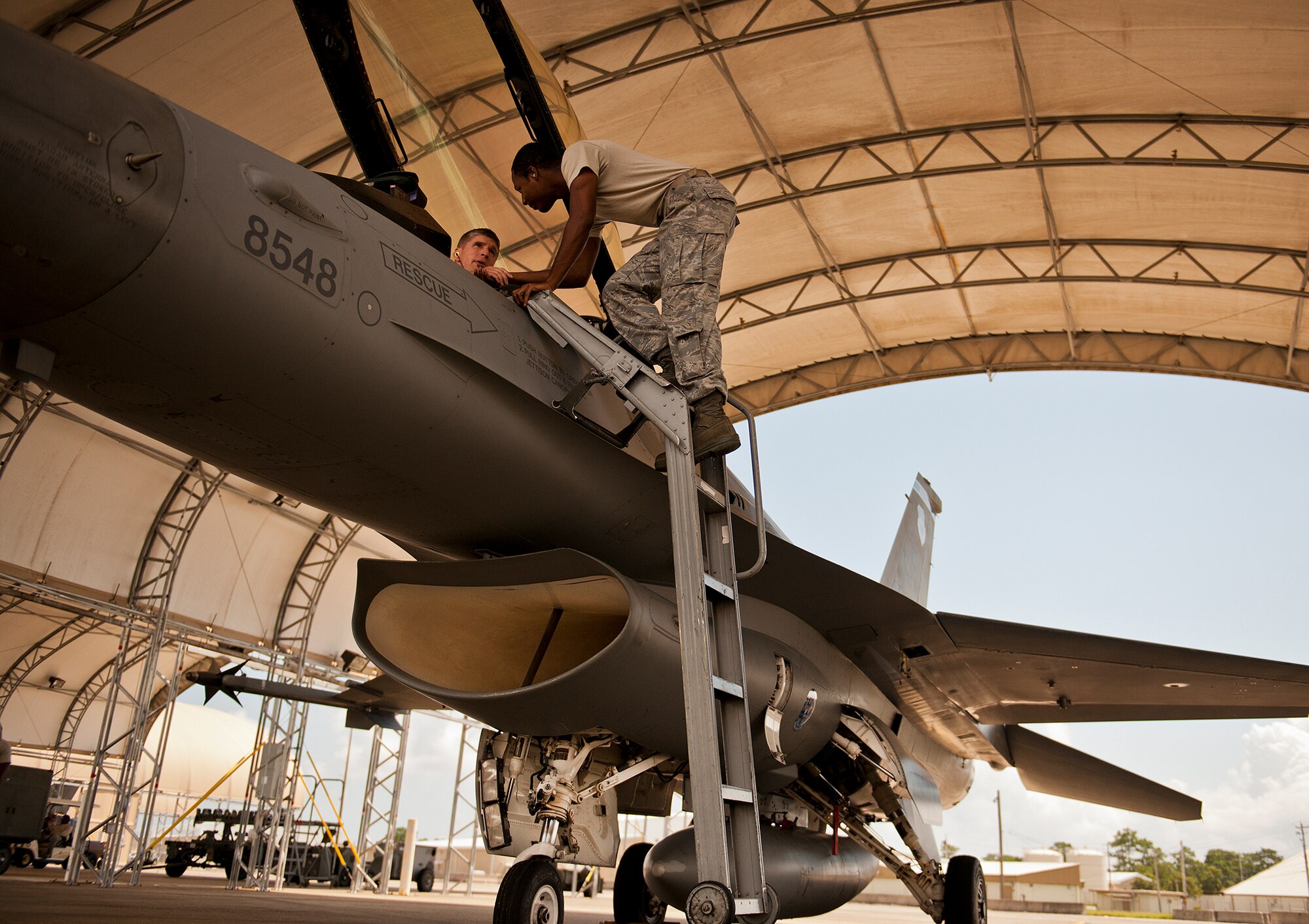 The crew chief receives a quick hand shake from the pilot before they begin the preflight checks of an F-16 Fighting Falcon on the 33rd Fighter Wing flightline Sept. 6 at Eglin Air Force Base, Fla.  Approximately 36 Luke Air Force Base Airmen, assigned to the 309th, maintain four F-16s used as chase aircraft for F-35 flights and to maintain pilot proficiency.  Airmen from Luke’s various F-16 maintenance squadrons have been rotating to Eglin to support this mission since January 2011.  (U.S. Air Force photo/Samuel King Jr.)