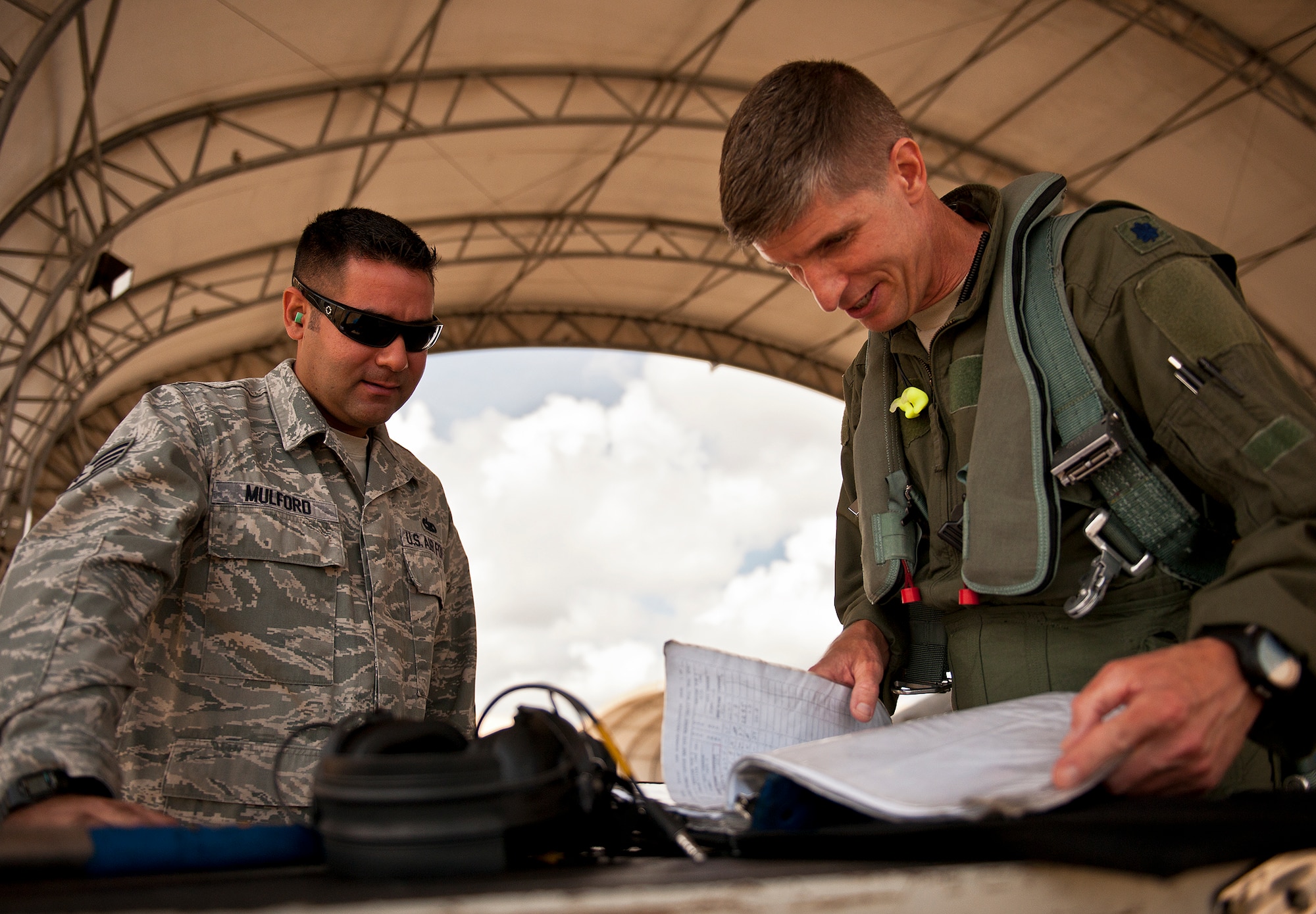 Staff Sgt. Mulford, of the 309th Aircraft Maintenance Squadron, and his aircraft's pilot, review the maintenance record of an F-16 Fighting Falcon prior to a sortie on the 33rd Fighter Wing flightline Sept. 6 at Eglin Air Force Base, Fla.  Approximately 36 Luke Air Force Base Airmen, assigned to the 309th, maintain four F-16s used as chase aircraft for F-35 flights and to maintain pilot proficiency.  Airmen from Luke’s various F-16 maintenance squadrons have been rotating to Eglin to support this mission since January 2011.  (U.S. Air Force photo/Samuel King Jr.)