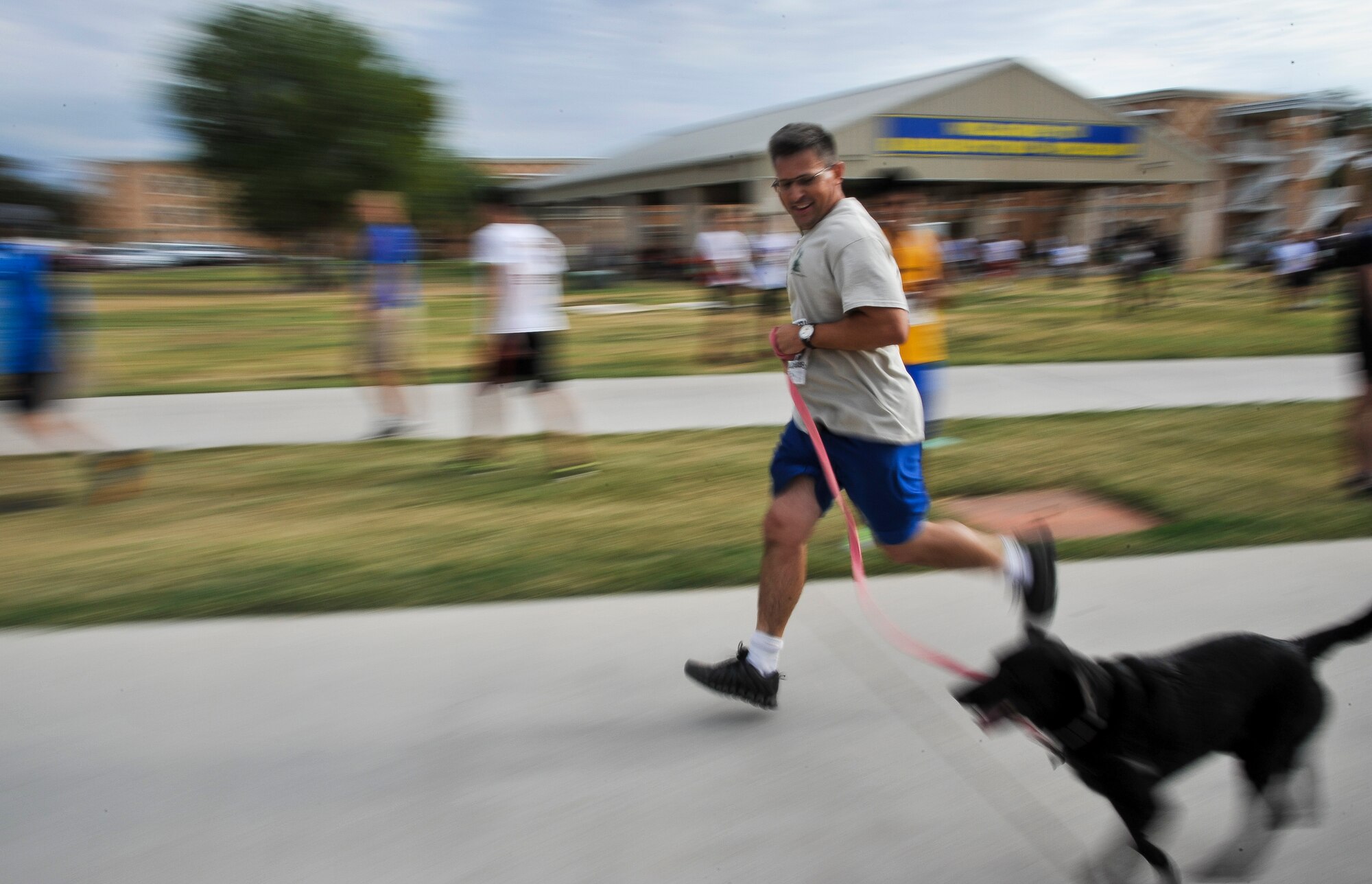 SAN ANGELO, Texas -- Samuel Spooner, 17th Training Wing Safety, runs with his dog Hope during Run to Remember at ASU Sept. 9. Run to Remember is a five km race and a one and a half mile race to commemorate the events that took place on Sept. 11, 2001. (U.S. Air Force photo/Airman 1st Class Michael Smith)