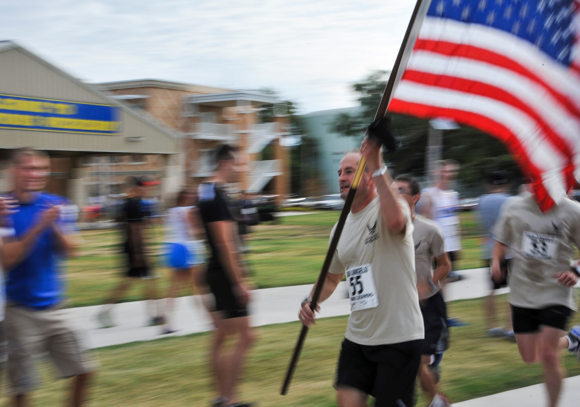 SAN ANGELO, Texas -- Robert Ehlers, Angelo State University Security Studies director, runs with the American Flag during Run to Remember at ASU Sept. 9. Run to Remember is a five km race and a one and a half mile race to commemorate the events that took place on Sept. 11, 2001. (U.S. Air Force photo/Airman 1st Class Michael Smith)