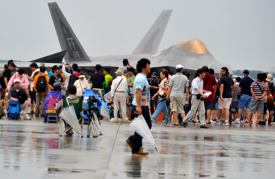 Attendees of the Air Fest look at a static display of an F-22 Raptor aircraft at Misawa Air Base, Japan, Sept. 9, 2012. Aircraft soared through the sky while others sat static for viewing during the Air Festival. (U.S. Air Force photo by Airman 1st Class Zachary Kee/Released)