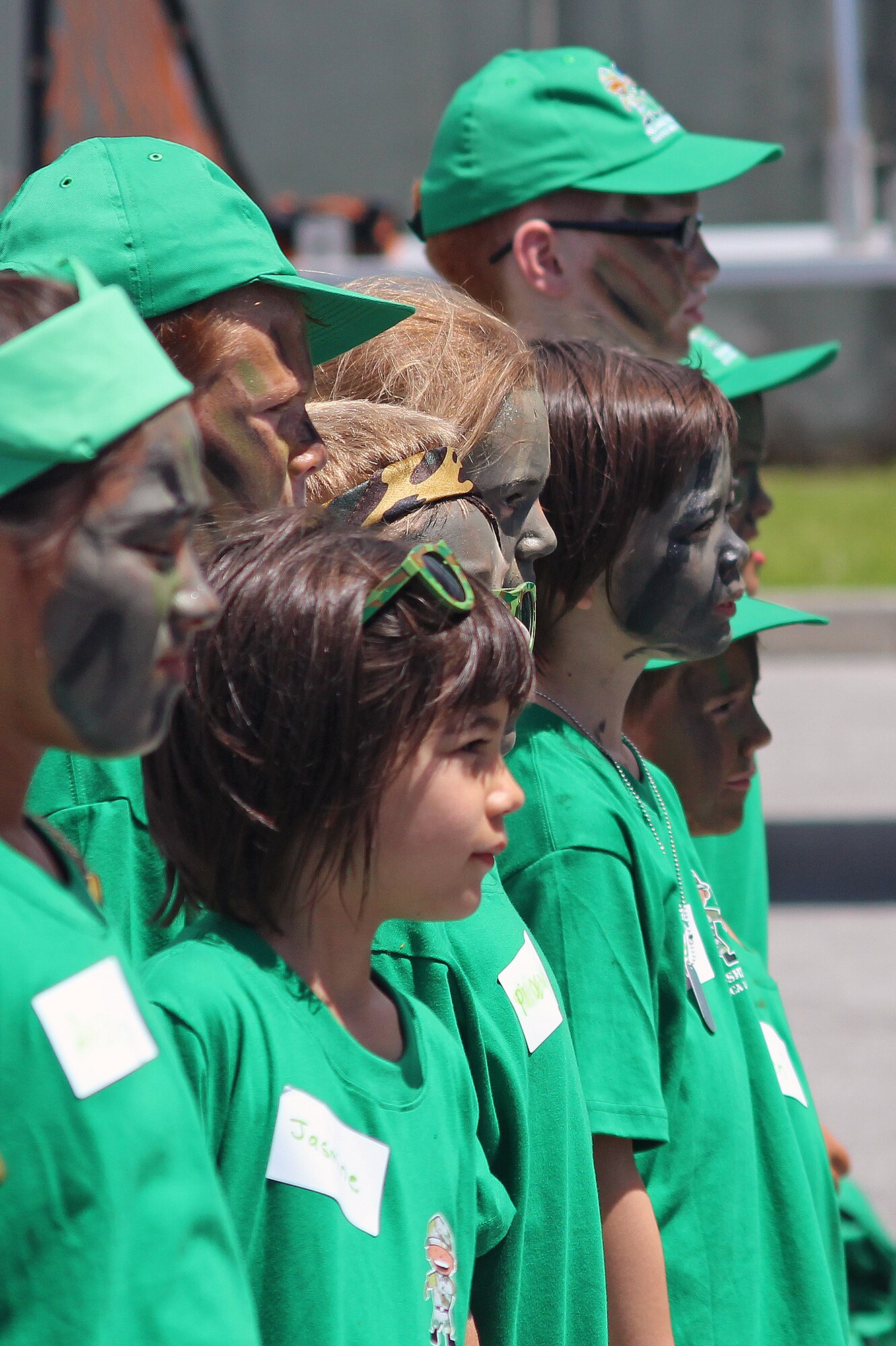 Children from Team Green stand at attention while participating in a drill contest with the Kadena first sergeants during Skoshi Warrior on Kadena Air Base, Japan, Sept. 8, 2012. More than 300 children and military volunteers participated in the event designed to show military children a fun example of their parents deployment process. (U.S. Air Force photo/Tech. Sgt. Jason Lake)