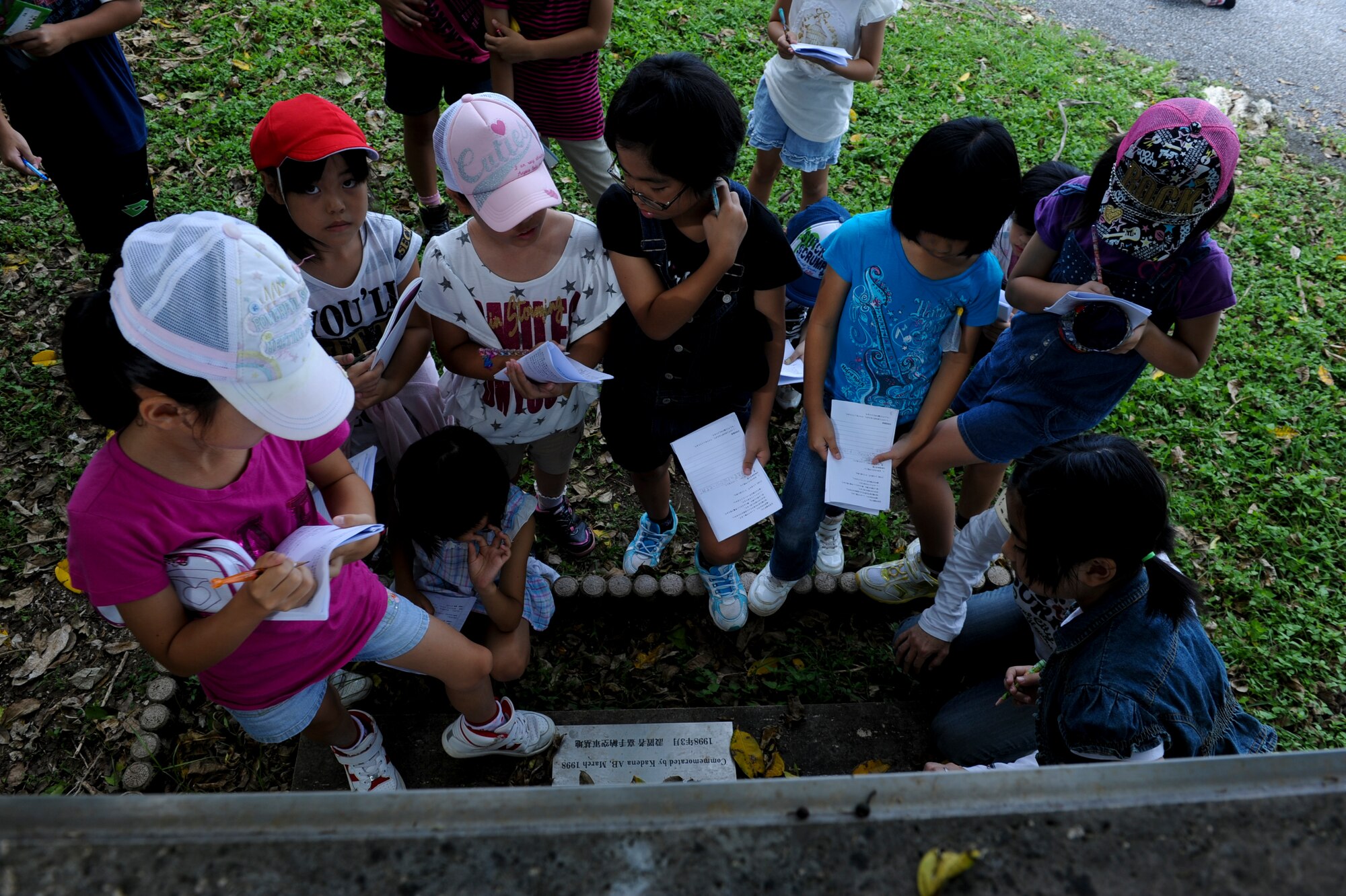Yara Elementary School students take notes during their social studies tour at the Kadena Marina on Okinawa, Japan, Sept. 7, 2010. More than 50 students visited the Tomb of Noguni Sokan, an Okinawan historical figure known for bringing the sweet potato from China to Okinawa, which saved the local people from starvation. (U.S. Air Force photo/Airman 1st Class Justin Veazie)
