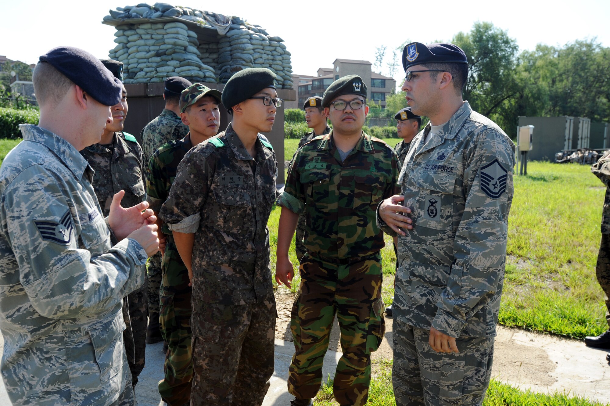 Airmen from the 51st Security Forces Squadron meet with representatives from the Republic of Korea Army Sept. 6, 2012, during a familiarization tour of Osan Air Base. The afternoon included a tour of defensive fighting positions from an air base defense perspective. (U.S. Air Force photo/Airman 1st Class Alexis Siekert)