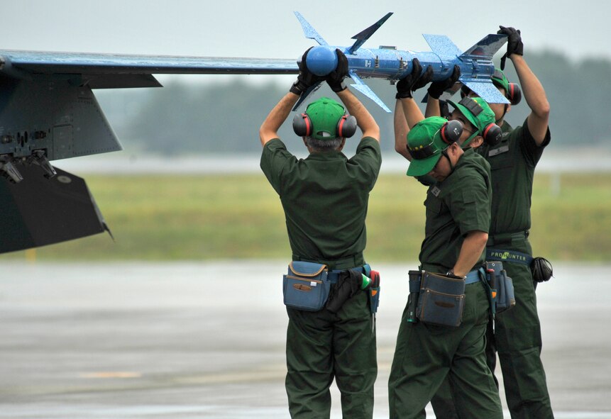 Japan Air Self-Defense Force weapon loaders demonstrate loading a missile during the Misawa Air Festival Sept. 9, 2012, at Misawa Air Base, Japan. Thousands of people from across Japan visited Misawa Air Base for this annual event, which displayed the teamwork and openness shared by U.S. and Japan forces. (U.S. Air Force photo by Staff Sgt. Nathan Lipscomb/Released)