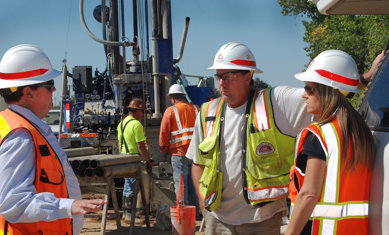 U.S. Army Corps of Engineers Sacramento District’s Erik James, lead geotechnical engineer; Jim Drysdale, senior geologist; and Kim Woolf, senior construction representative, confer as a crew prepares to extract test cores of material from recently placed cutoff wall sections in the Marysville Ring Levee. (U.S. Army photo/Released)