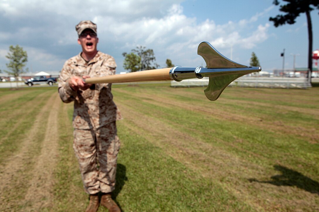 Cpl. Nathan W. Poulter,  an EA-6B Prowler airframe mechanic and student with class 274-12, "presents guidon" while shouting the command during an introduction to guidon manual, Aug. 17. The three-week course is the first Professional Military Education class enlisted Marines attend and focuses on leadership, history and tradition of Marine Corps corporals.
