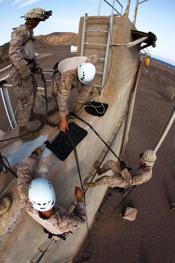 Marines with Battalion Landing Team 1st Battalion, 2nd Marine Regiment, 24th Marine Expeditionary Unit, rappel down a training tower during assault climber training in Djibouti, Aug. 29, 2012. The training is a part of a Training Force, or T-Force, package focused on primitive infantry skills. The 24th MEU is deployed with the Iwo Jima Amphibious Ready Group as a theater reserve and crisis response force throughout the U.S. Central Command in the Navy's 5th Fleet area of responsibility.