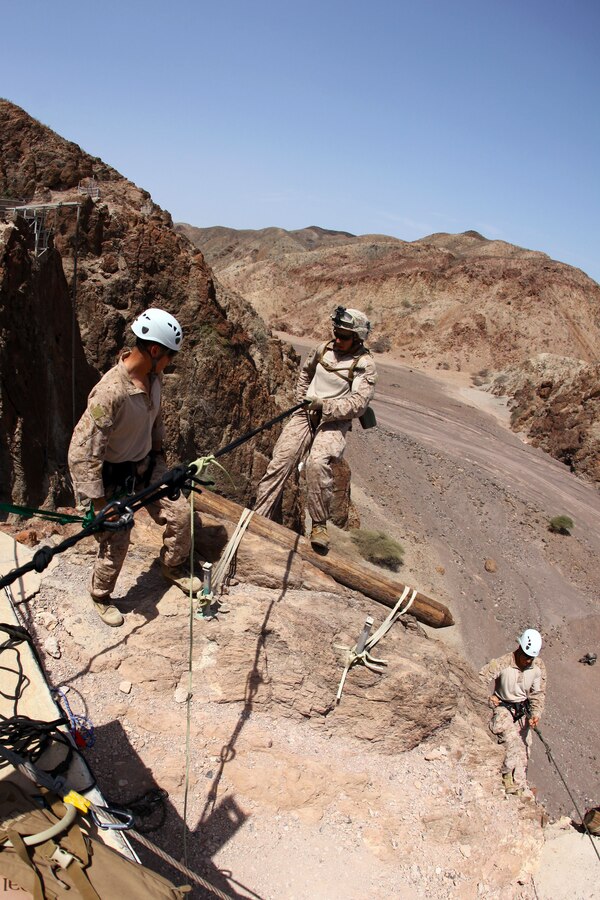 Seaman Marcus Fluke, center, a hospital corpsman, and Bedford, Pa., native with Bravo Company,  Battalion Landing Team 1st Battalion, 2nd Marine Regiment, 24th Marine Expeditionary Unit, rappels from a 150 ft. cliff side during assault climber training in Djibouti, Aug. 29, 2012.  The training is a part of a Training Force, or T-Force, package focused on primitive infantry skills. The 24th MEU is deployed with the Iwo Jima Amphibious Ready Group as a theater reserve and crisis response force throughout the U.S. Central Command in the Navy's 5th Fleet area of responsibility.