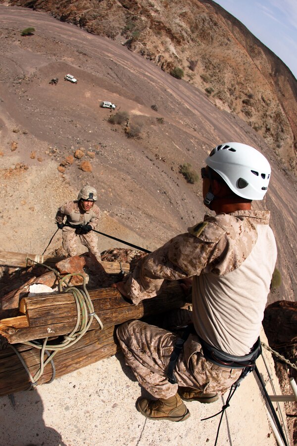 Lance Cpl. Andrew Ondish, left, an assaultman, and Shavertown, Pa., native with Bravo Company,  Battalion Landing Team 1st Battalion, 2nd Marine Regiment, 24th Marine Expeditionary Unit, rappels from a 150 ft. cliff side during assault climber training in Djibouti, Aug. 29, 2012.  The training is a part of a Training Force, or T-Force, package focused on primitive infantry skills. The 24th MEU is deployed with the Iwo Jima Amphibious Ready Group as a theater reserve and crisis response force throughout the U.S. Central Command in the Navy's 5th Fleet area of responsibility.
