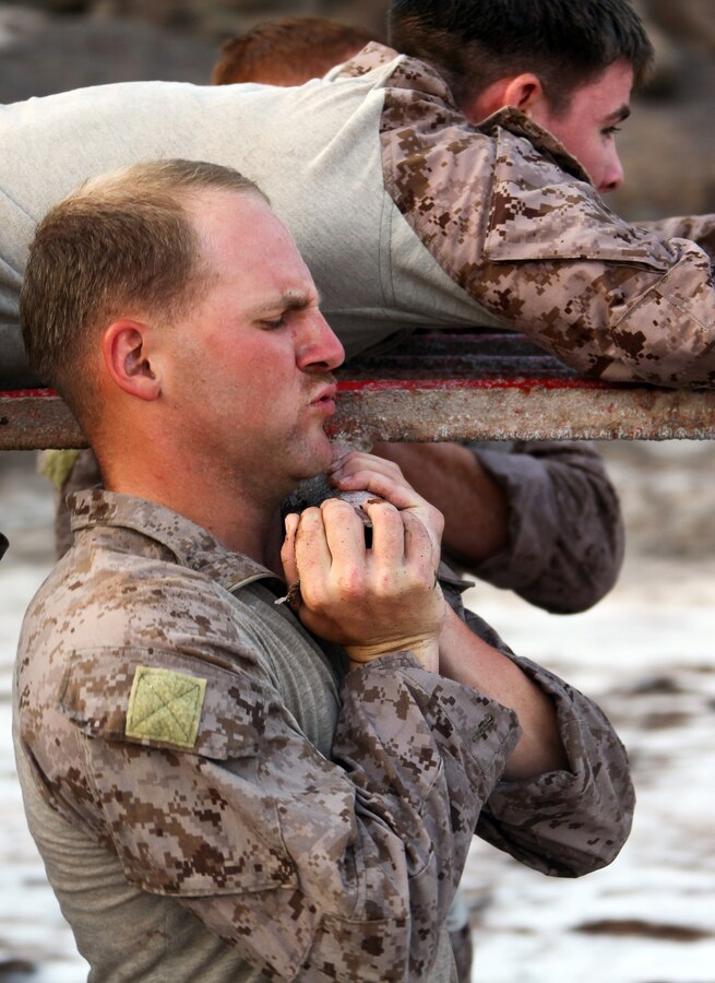 Cpl. Lucas McKay, a Lexington, S.C., native and squad leader with Bravo Company, Battalion Landing Team 1st Battalion, 2nd Marine Regiment, 24th Marine Expeditionary Unit, helps carry a fellow Marine on a stretcher prior to a water obstacle course in Djibouti, Aug. 30, 2012. The course is a part of a Training Force, or T-Force, package focused on primitive infantry skills. The 24th MEU is deployed with the Iwo Jima Amphibious Ready Group as a theater reserve and crisis response force throughout the U.S. Central Command in the Navy's 5th Fleet area of responsibility.