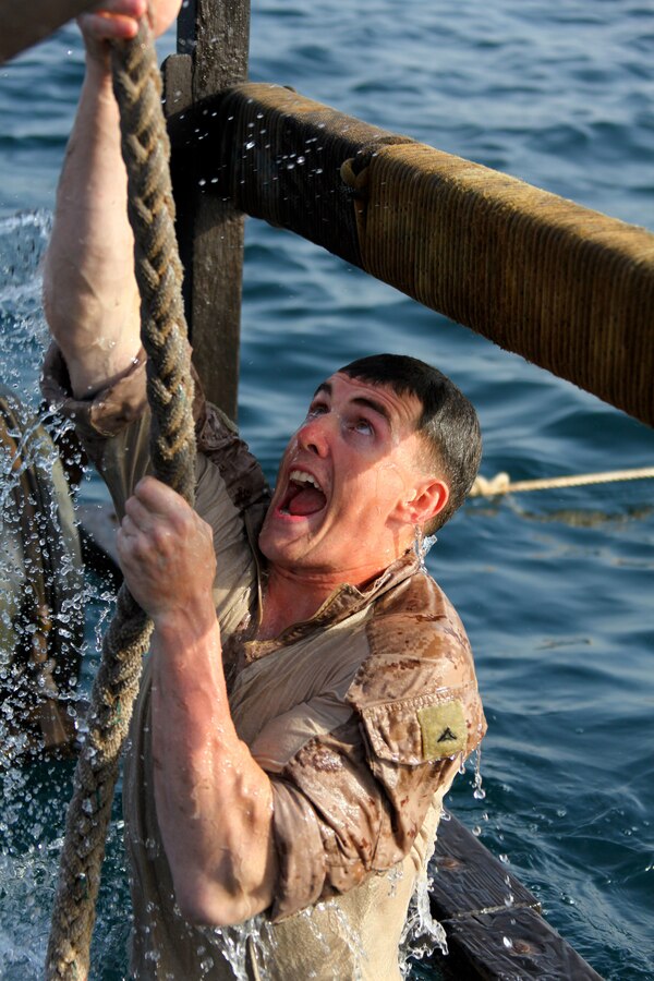 Lance Cpl. Kevin Midgley, a Westlake, Ohio, native and team leader with Bravo Company, Battalion Landing Team 1st Battalion, 2nd Marine Regiment, 24th Marine Expeditionary Unit, climbs a rope as part of a water obstacle course in Djibouti, Aug. 30, 2012. The course is a part of a Training Force, or T-Force, package focused on primitive infantry skills. The 24th MEU is deployed with the Iwo Jima Amphibious Ready Group as a theater reserve and crisis response force throughout the U.S. Central Command in the Navy's 5th Fleet area of responsibility.