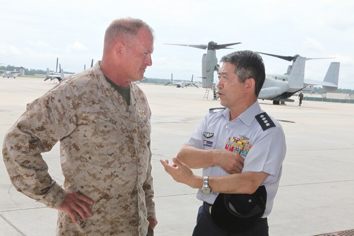 Maj. Gen. Raymond C. Fox, commanding general of the 2nd Marine Expeditionary Force and General Shigeru Iwasaki, Air Self-Defense Force, Chief of Staff, Joint Staff, Japan Self-Defense Forces, discuss the MV-22B Osprey during the Japanese government's visit to Marine Corps Air Station New River, Aug. 21. The Marine Corps is transitioning the Osprey to Japan later this year, but before this happens, the Japanese government wanted to get a first-hand look at the aircraft. Marines from Marine Medium Tiltrotor Training Squadron 204 and Marine Medium Tiltrotor Squadron 264 showed the Japanese officials various aspects of the Osprey.
