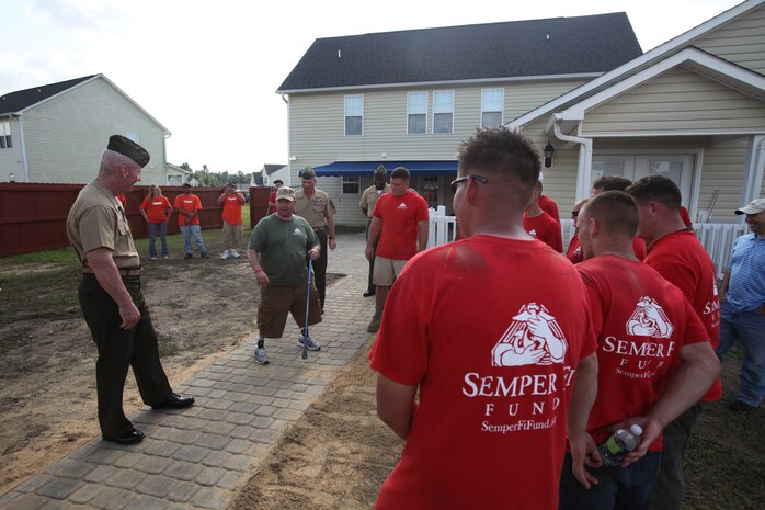 Sgt. Maj. Mackey tries out his new walking path through his back yard on Aug. 30. Mackey took the time to stop and chat and also thank some of the volunteers who had been providing he improvements on his house.
