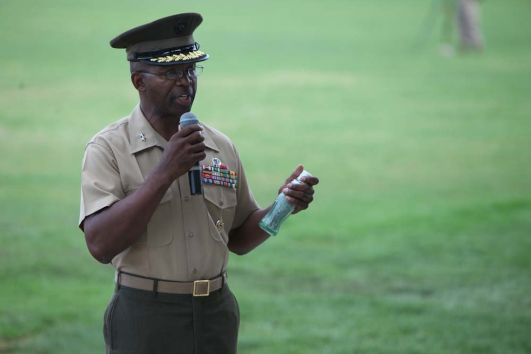 Major Gen. Ronald L. Bailey, the 1st Marine Division commanding general, shows audiences a bottle of sand from Guadalcanal during a battle color rededication ceremony on the division parade field here, Aug. 30. The Marines demonstrated tenacity and valor at the battle of Guadalcanal, and the 1st Marine Division logo features the word “Guadalcanal” in honor of the battle. Bailey fastened 25 streamers to the battle color signifying various campaigns, expeditions, battles, and decorations presented to the division since its founding, from the occupation of Haiti in 1915 to Operation Enduring Freedom in Afghanistan. The ceremony was directed by the commanding general of the 1st Marine Division as a part of the Commandant’s guidance to refocus Marines on their core values and identity. (U.S. Marine Corps photo by Cpl. Sarah B. Novotny)