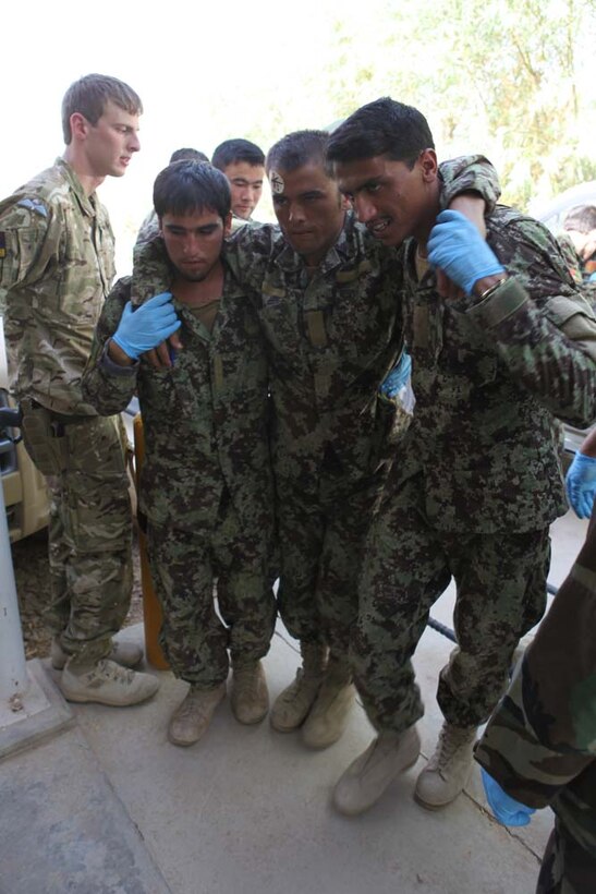 Soldiers with the Afghan National Army carry a simulated casualty into their emergency room to treat him for his wounds as part of a mass casualty simulation exercise held, Sept. 9, 2012. During the mass casualty simulation, members of the Afghan National Army were given a list of symptoms and wounds. ANA medics then had to determine the proper way to treat them and who needed to be treated first depending on their wounds.