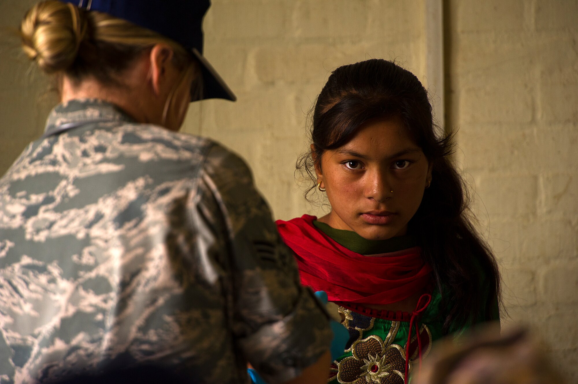 Senior Airman Kendall Thompson, 36th Medical Group, Anderson AFB, Guam treats a 12-year-old Nepali girl, who cut her hand while working in the fields near her home, during U.S. Pacific Command's Operation Pacific Angel 12-4, Nepal on Sept. 10, 2012. Pacific Angel 12-4 is a Pacific Air Forces planned event that enhances humanitarian assistance and disaster relief capabilities between the United States and Pacific partners. The U.S. was invited by the Nepal government to provide support by conducting medical, optometry, and civil engineering programs. Operations like Pacific Angel build and sustain relationships with our multinational partners in the Asia-Pacific region. (U.S. Air Force photo/Master Sgt. Jeffrey Allen)
