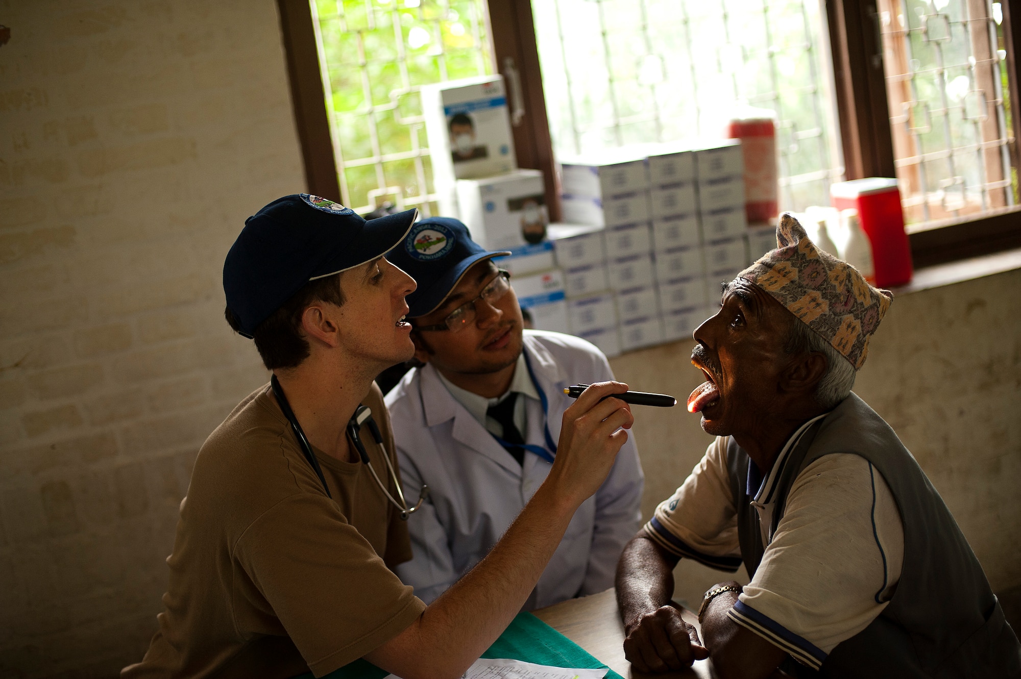 Flight Lt. Christopher Gilbert, Royal Australian Air Force, treats a Nepali man during U.S. Pacific Command's Operation Pacific Angel 12-4, Nepal on Sept 10, 2012. Pacific Angel 12-4 is a Pacific Air Forces planned event that enhances humanitarian assistance and disaster relief capabilities between the United States and Pacific partners. Operation Pacific Angel is witnessing active participation of doctors from the Nepal Army, US Air Force (PACAF), Royal Australian Air Force, Mongolian Army, Project HOPE, Western Regional Hospital, Gandaki Medical College Teaching Hospital (Charak) and Himalaya Eye Hospital. The U.S. was invited by the Nepal government to provide support by conducting medical, optometry, and civil engineering programs. Operations like Pacific Angel build and sustain relationships with our multinational partners in the Asia-Pacific region. (U.S. Air Force photo/Master Sgt. Jeffrey Allen)

