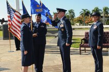 Lt. Col. Michael J. Fea salutes Col. Robie V. Hughes, Commander, 15th Medical Group, as he assumes command of the 15th Medical Operations Squadron (MDOS), Joint Base Pearl Harbor-Hickam, Hawaii on 2 Aug 2012. Lt. Col. Rene J. Chadwell (right) is the former 15th MDOS commander.  Photo by David D. Underwood, Jr.