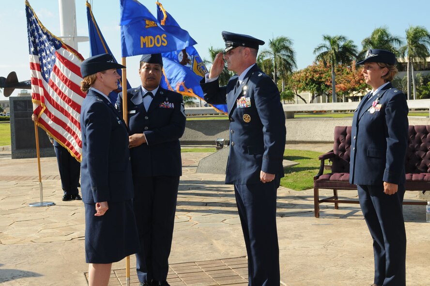 Lt. Col. Michael J. Fea salutes Col. Robie V. Hughes, Commander, 15th Medical Group, as he assumes command of the 15th Medical Operations Squadron (MDOS), Joint Base Pearl Harbor-Hickam, Hawaii on 2 Aug 2012. Lt. Col. Rene J. Chadwell (right) is the former 15th MDOS commander.  Photo by David D. Underwood, Jr.