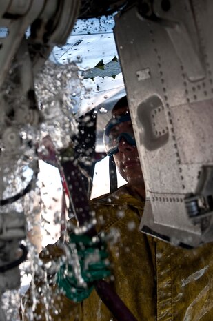 U.S. Air Force Airman 1st Class Garrett Sterba, 757th Aircraft Maintenance Squadron electronic environmental journeyman, sprays water underneath an F-15E Strike Eagle at the wash rack here Sept. 10, 2012, at Nellis Air Force Base, Nev. Washing an F-15E Strike Eagle takes approximately four hours for a crew of three to clean the aircraft and reduce corrosion and salt build up. (U.S. Air Force photo by Staff Sgt. Christopher Hubenthal)