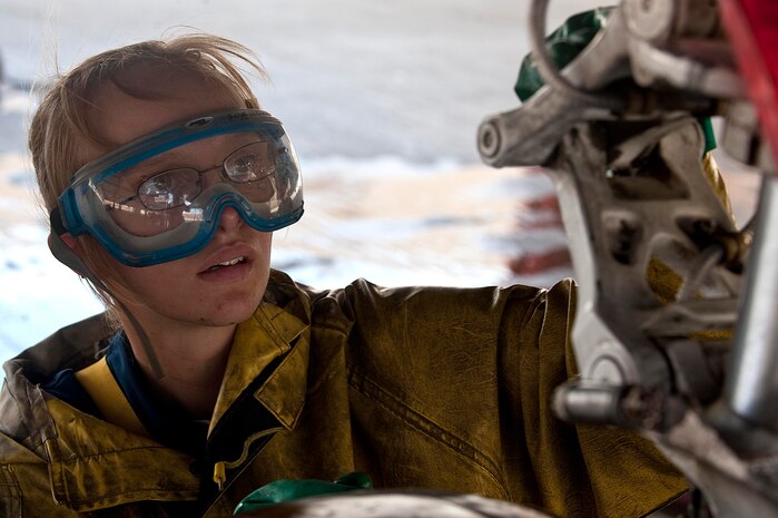 U.S. Air Force Senior Airman Candace Obeginski, 757th Aircraft Maintenance Squadron crew chief, scrubs underneath an F-15E Strike Eagle at the wash rack here Sept. 10, 2012, at Nellis Air Force Base, Nev. Washing an F-15E Strike Eagle takes approximately four hours for a crew of three to clean the aircraft and reduce corrosion and salt build up. (U.S. Air Force photo by Staff Sgt. Christopher Hubenthal)