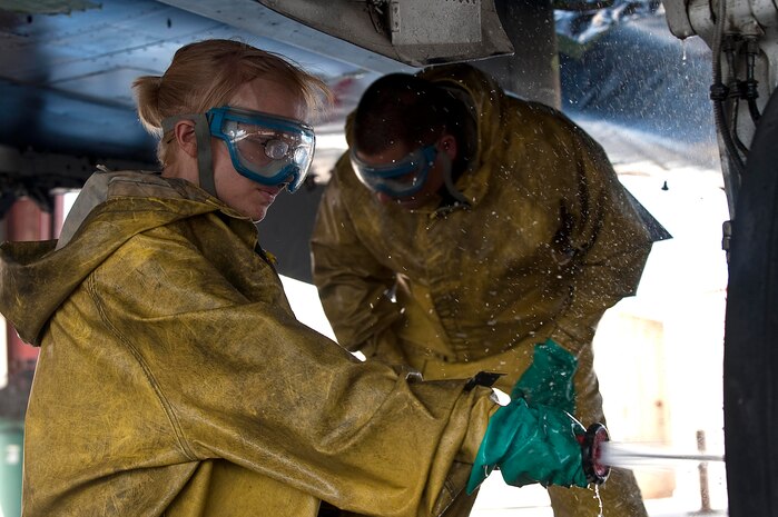 U.S. Air Force Senior Airman Candace Obeginski, crew chief, and Airman 1st Class Garrett Sterba, electronic environmental journeyman, both from the 757th Aircraft Maintenance Squadron clean the tires of an F-15E Strike Eagle at the wash rack here Sept. 10, 2012, at Nellis Air Force Base, Nev. Washing aircraft every 180 days at Nellis AFB helps to extend its life and reliability by preventing corrosion build-up. The more exposure an installation has to salt water the more frequently the aircraft is required to be washed.  (U.S. Air Force photo by Staff Sgt. Christopher Hubenthal)