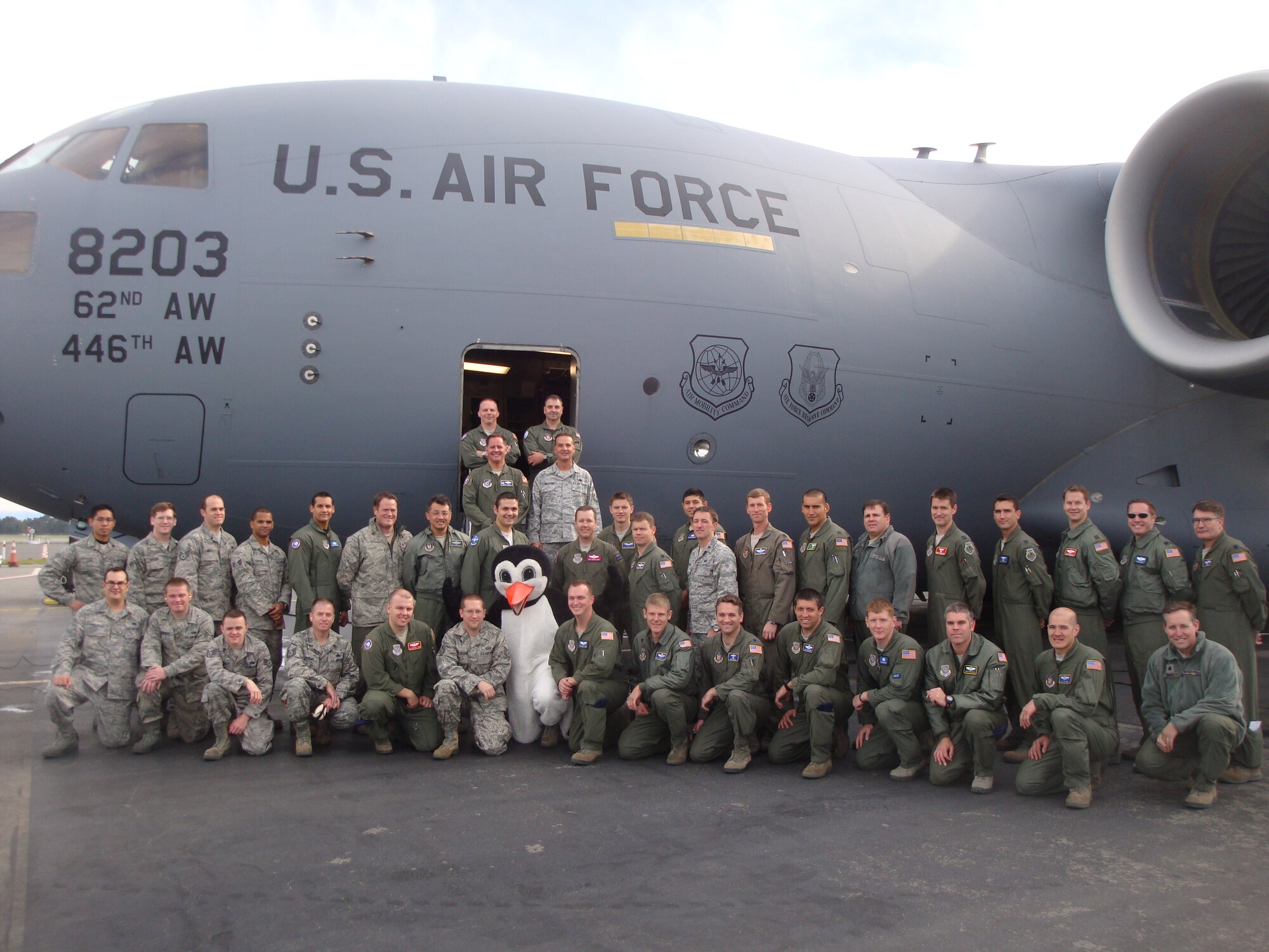 Members of the 304th Expeditionary Airlift Squadron stand beside a C-17 Globemaster III aircraft deployed to Christchurch International Airport, New Zealand from Joint Base Lewis-McChord, Wash., to conduct winter flying into McMurdo Station, Antarctica. During the period, crews transported 388 passengers and 265,000 pounds of cargo into and out of the remote airfield in preparation for the main season of Operation Deep Freeze. (U.S. Air Force courtesy photo)